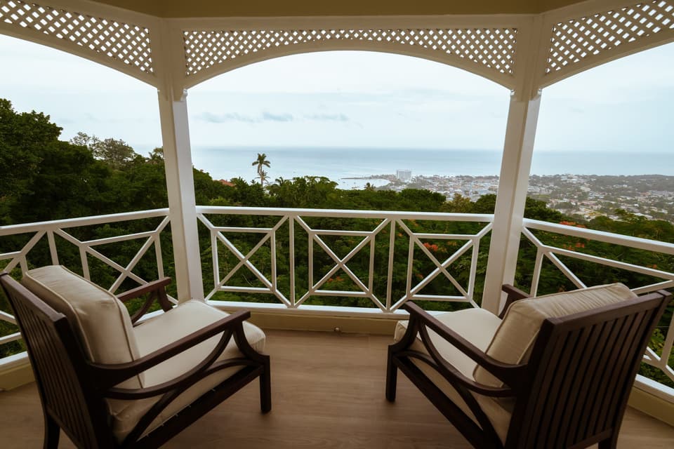 Two armchairs on the upper balcony of Bay Vista Villa facing the bay of Ocho Rios