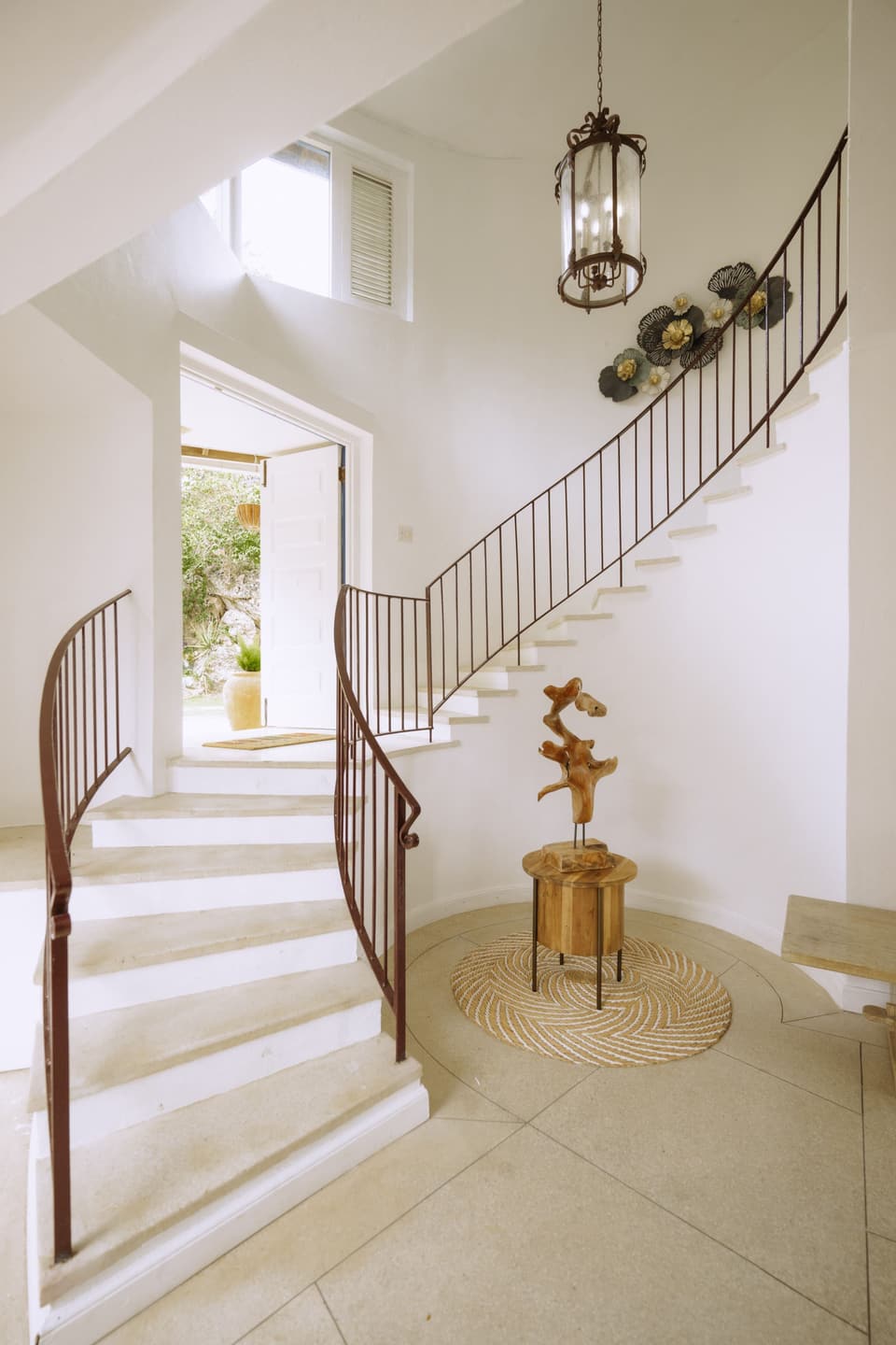 The winding double staircase in the entrance hall of Bay Vista Villa